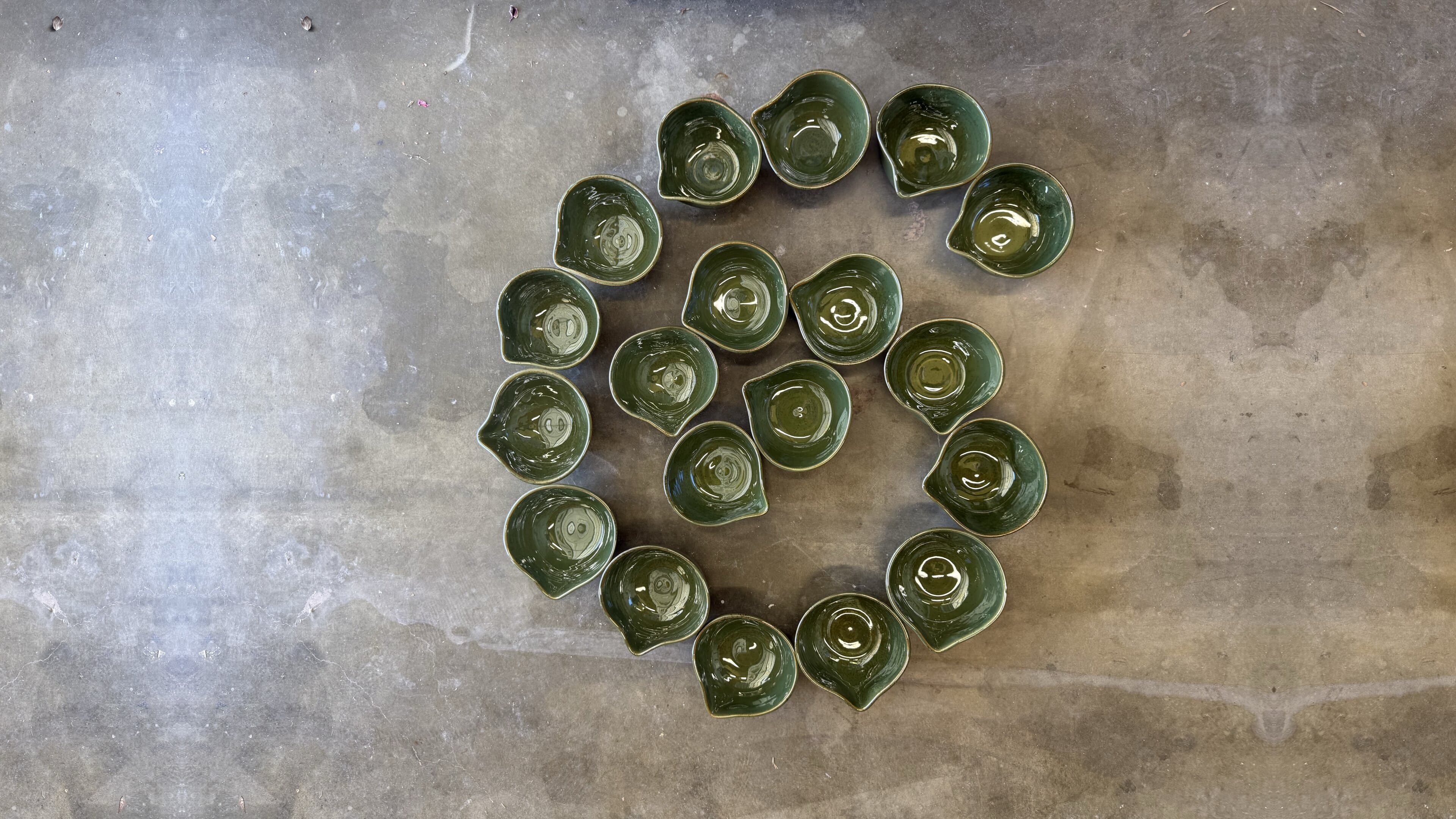 Studio Nia green spouted bowls arranged in a spiral