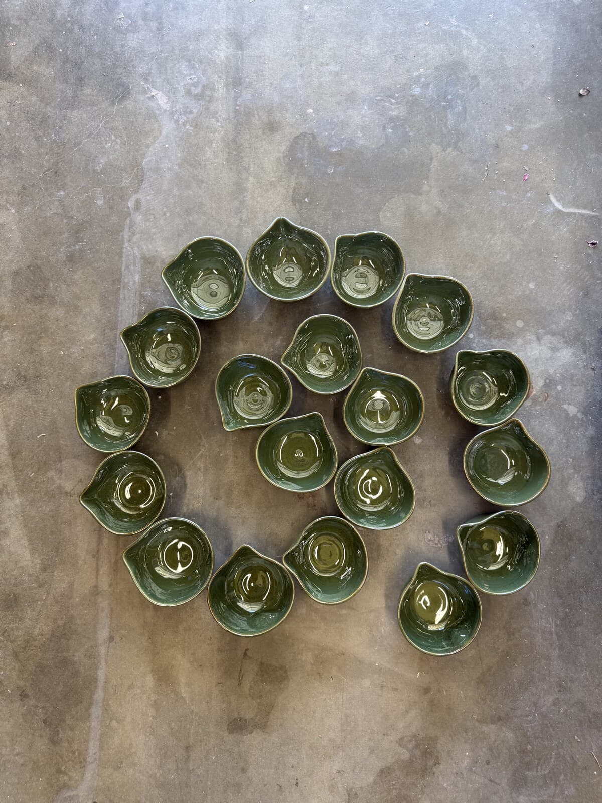 Studio Nia green spouted bowls arranged in a spiral