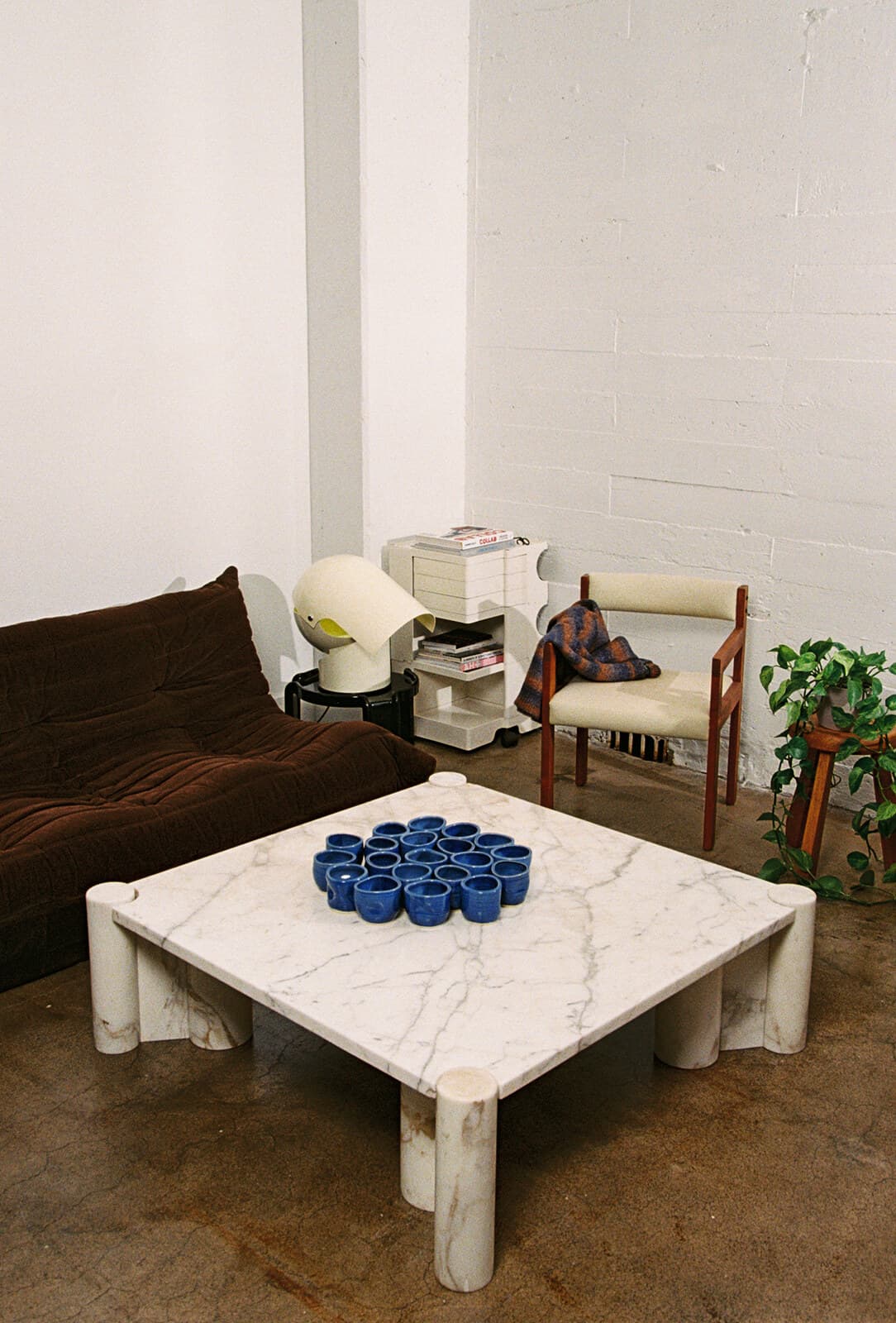 Studio Nia blue cups on a marble table in a sunlit loft