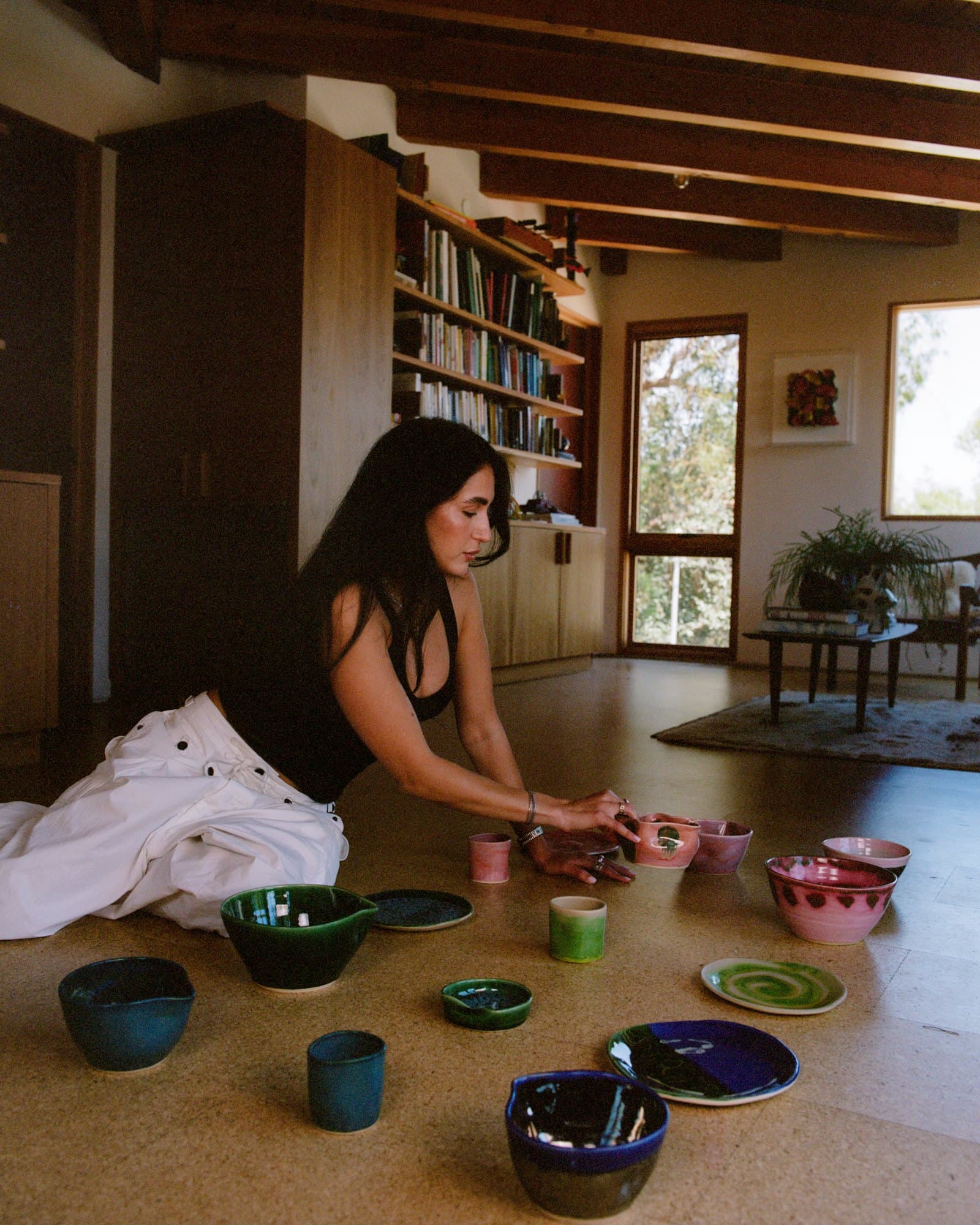 Daniella arranging Studio Nia pieces on the floor
