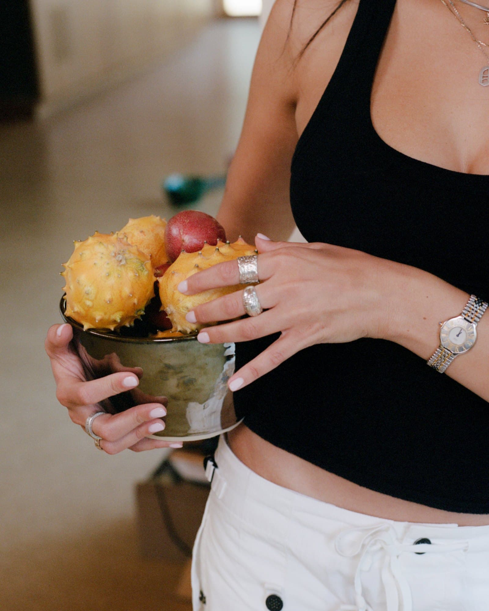 Daniella holding a Studio Nia bowl filled with fruit