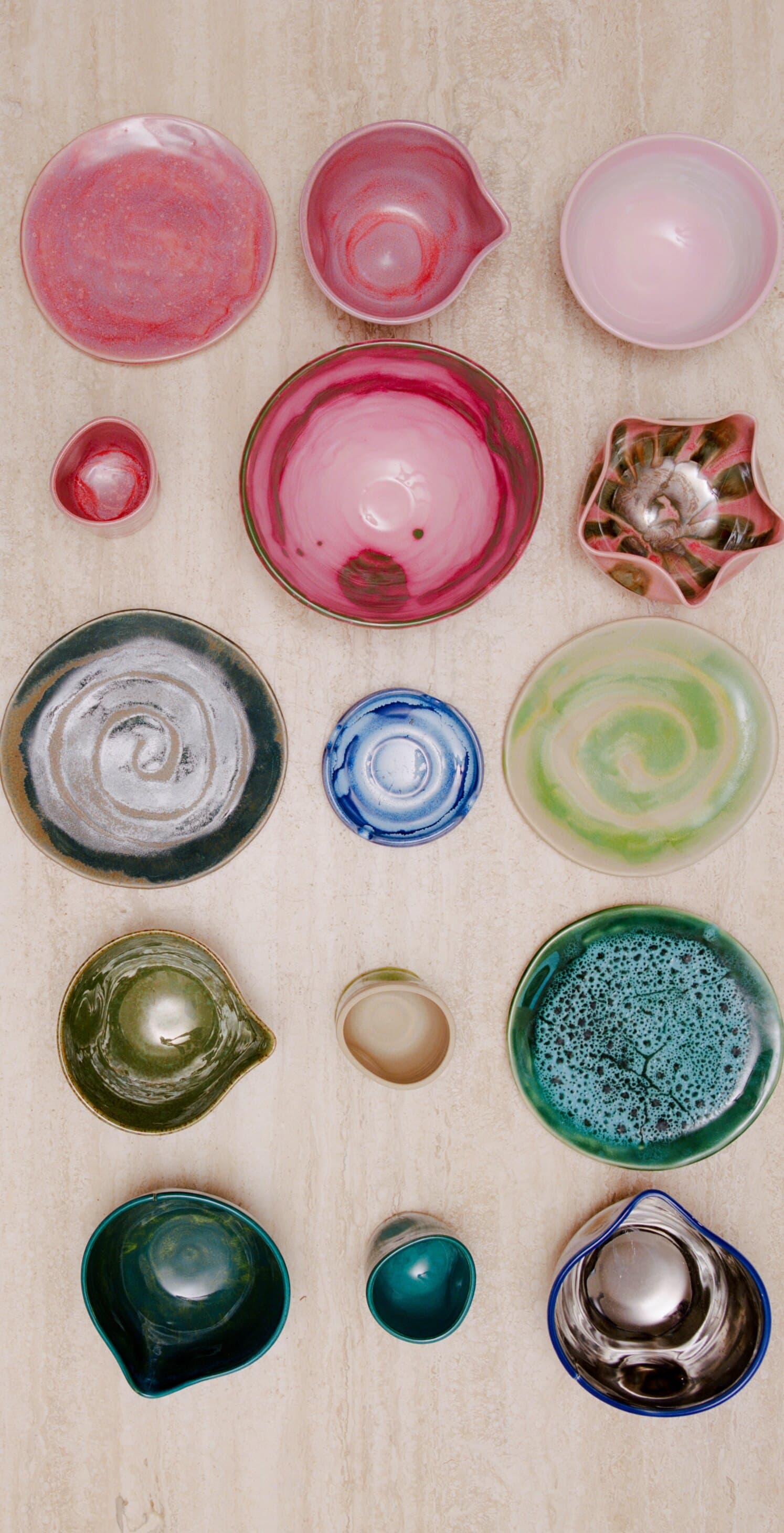 Studio Nia bowls, cups and plates laid out on travertine